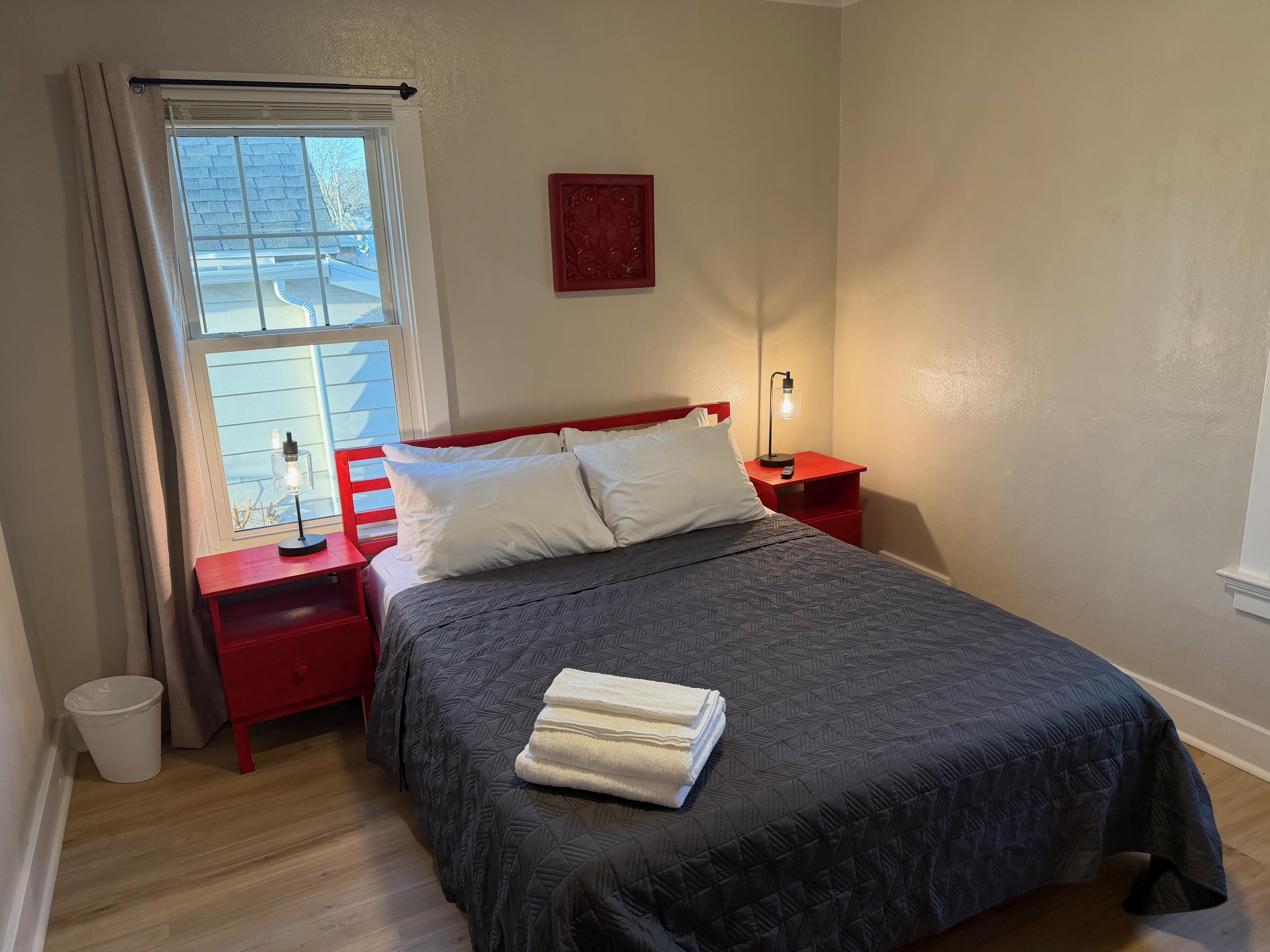 Bedroom 2 with red accents and queen bed, The Land of Cleve Dayton OH