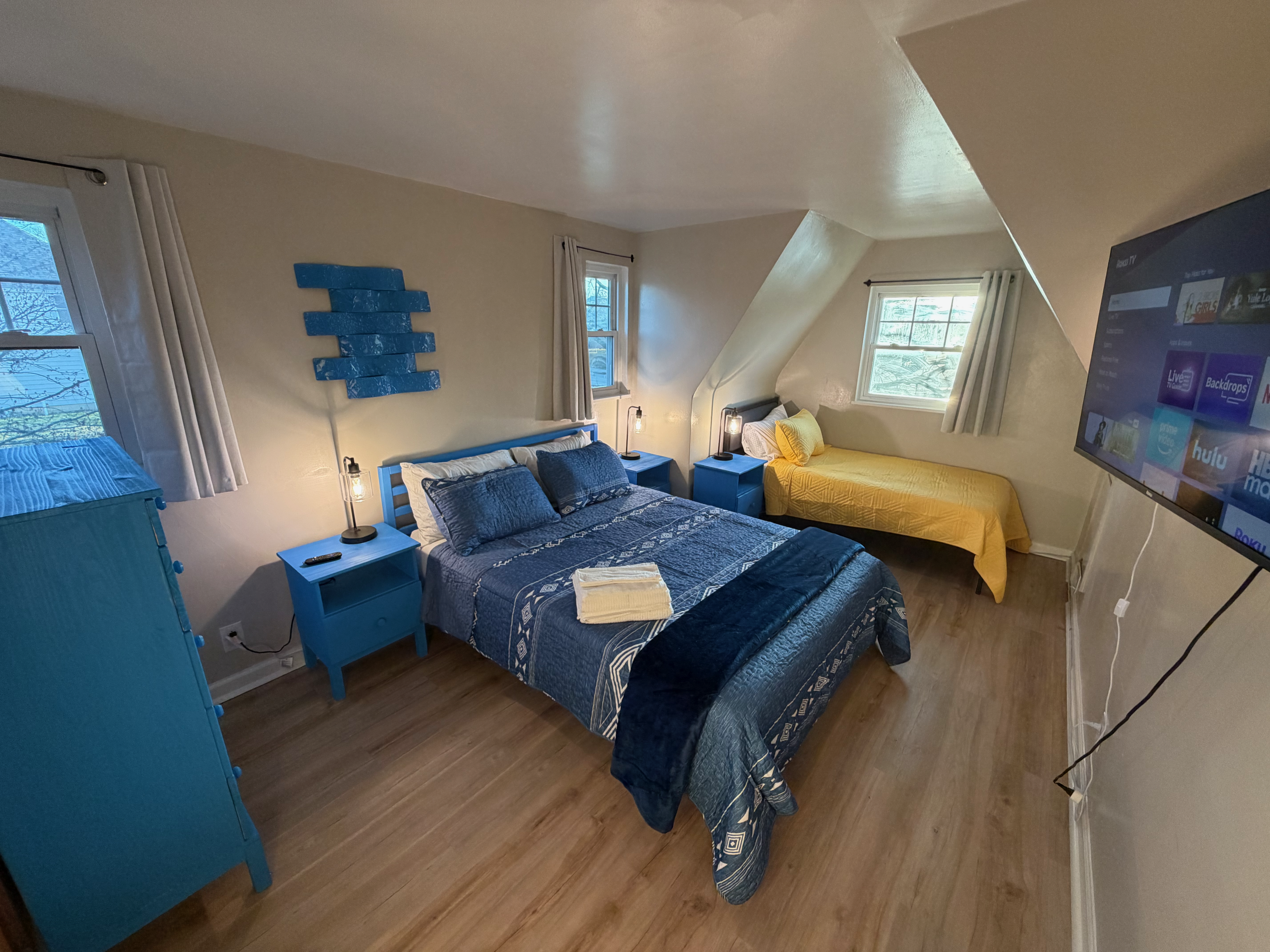 Blue-themed bedroom with queen and twin beds at The Land of Cleve, Dayton OH